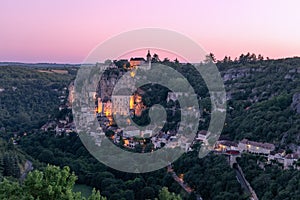 Dust falls on 3 levels of Rocamadour village and first illumination from sanctuaries appears.Â Lot, Occitania, Southwestern France